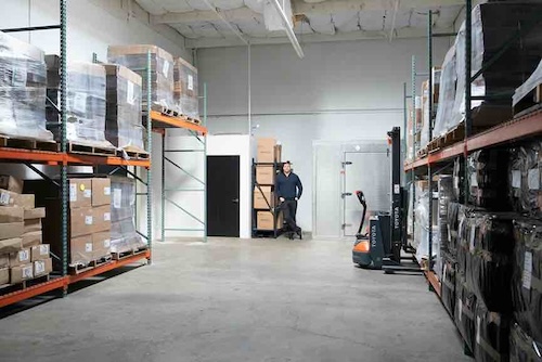 A man standing in a warehouse
